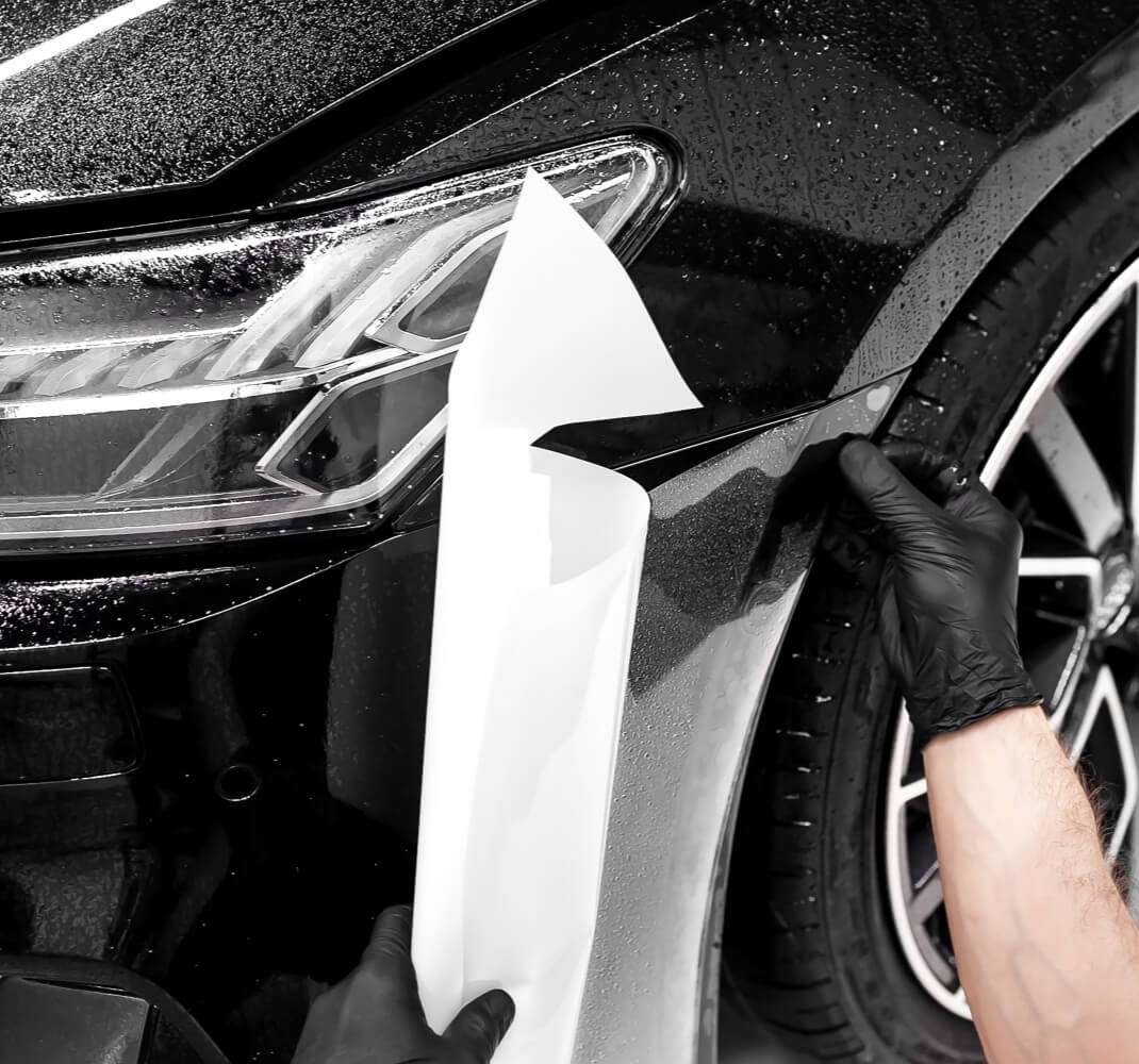 paint protection film installation on a black car